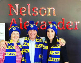 a family photo of eels supporters wearing scarves and beanies